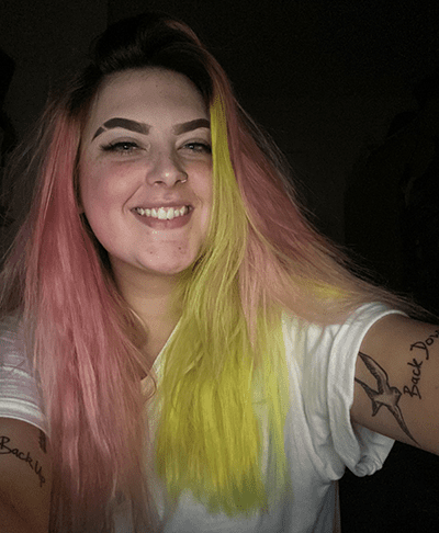 Profile of volunteer Abbie, woman with long pink and yellow hair